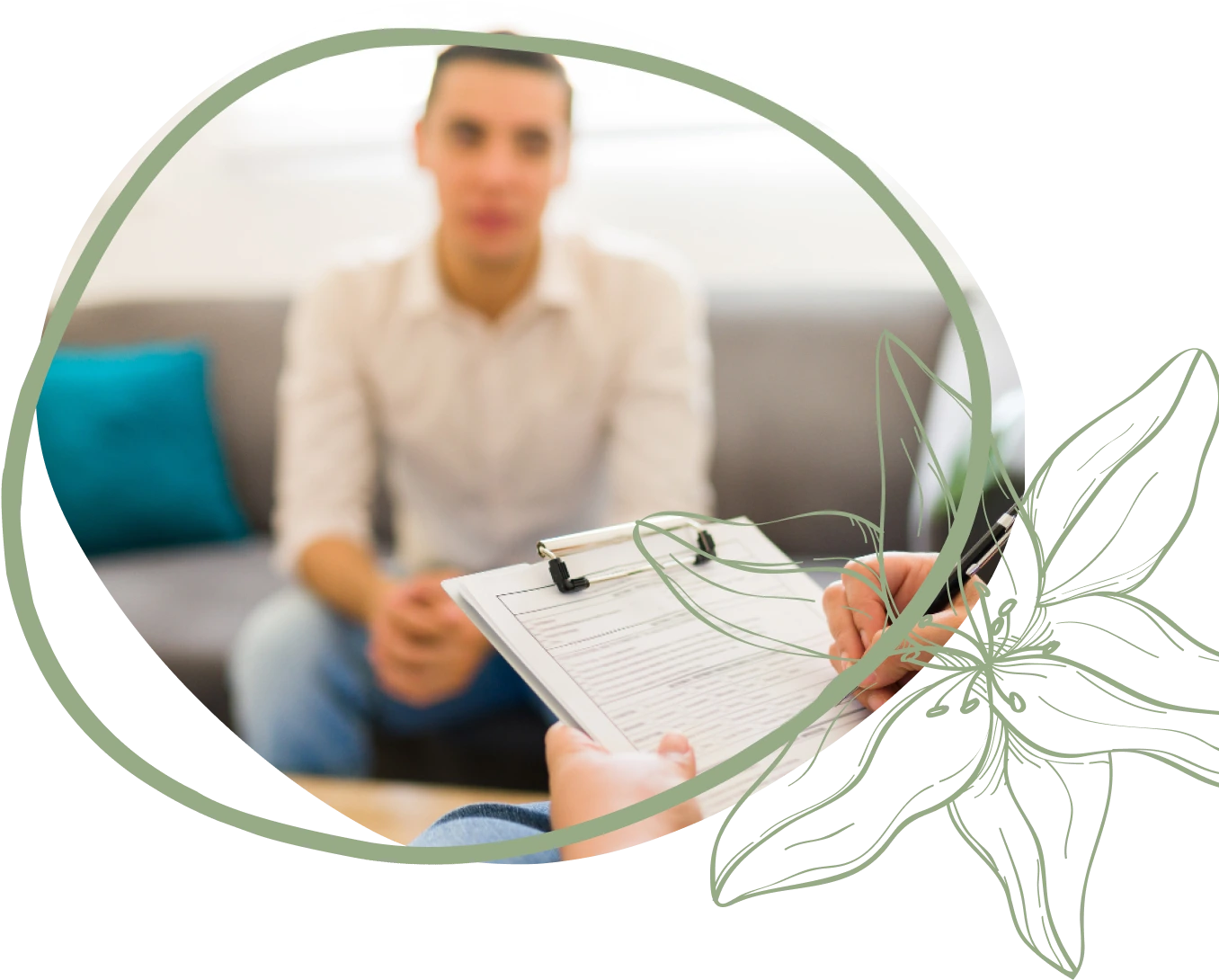 A person sits on a couch, with a clipboard and pen in the foreground, engaged in a discussion or interview.