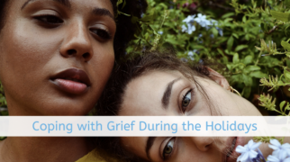 A sunny outdoor scene featuring vibrant greenery and blue flowers, with a text overlay reading "Coping with Grief."