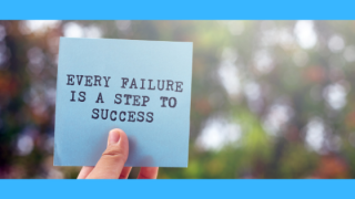 A hand holds a blue card with the motivational message: "Every failure is a step to success," against a blurred outdoor background.