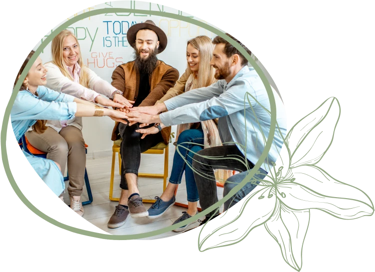 A group of people gather in a circle, placing their hands together in a show of unity and teamwork, with a colorful background.